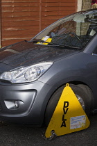 Law & Order, Traffic Control, Parking, Front wheel of car clamped by DVLA with ticket stuck to windscreen,