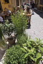 France, Provence-Alpes-Cote d'Azur, Antibes, Narrow street in the Old town with eople sat outside restaurants.