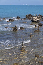 France, Provence-Alpes-Cote d'Azur, Antibes, Rock balanced stacks in shallow water.