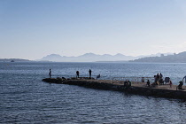 France, Provence-Alpes-Cote d'Azur, Antibes, Juan-les-Pins, People fishing from jetty.