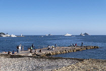 France, Provence-Alpes-Cote d'Azur, Antibes, Juan-les-Pins, People fishing from jetty.