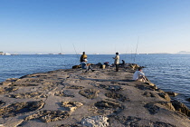 France, Provence-Alpes-Cote d'Azur, Antibes, Juan-les-Pins, People fishing from jetty.