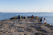 France, Provence-Alpes-Cote d'Azur, Antibes, Juan-les-Pins, People fishing from jetty.