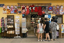 Spain, Valencia Province, Valencia, Ciutat Vella, Old Town, Tourist shop and tourists in Calle Serranos.