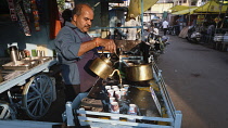 India, Gujarat, Ahmedabad, Tea vendor in the market.