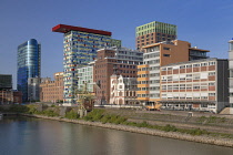 Germany, North Rhine-Westphalia, Dusseldorf, MedienHafen or Media Harbour area, The Colorium Building designed by British architect Will Alsop and standing 17 stories tall along the Rhine, catches the...