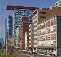 Germany, North Rhine-Westphalia, Dusseldorf, MedienHafen or Media Harbour area, The Colorium Building designed by British architect Will Alsop and standing 17 stories tall along the Rhine, catches the...