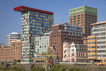 Germany, North Rhine-Westphalia, Dusseldorf, MedienHafen or Media Harbour area, The Colorium Building designed by British architect Will Alsop and standing 17 stories tall along the Rhine, catches the...