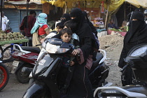 India, Tamil Nadu, Auraungabad, Woman on scooter with children without helmets.