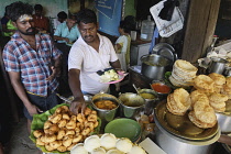 India, Tamil Nadu, Chennai, People serving food for themselves.