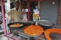 India, Tamil Nadu, Hyderabad, Man cooking jalebi in the market.