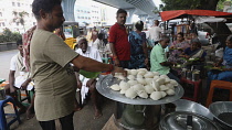 India, Tamil Nadu, Tirupathi, Idli rice ckaes being cooked in the market.