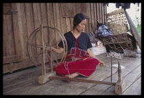 Thailand, Karen woman spinning wool.