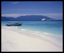 Malaysia, East Coast, Tioman Island, Sandy beach on W.Coast of island  boat.