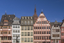 Germany, Hesse, Frankfurt, Altstadt Old Town, Romerberg, the square's east side known as the Ostzeile with the Statue of Justice in the foreground and the spire of Frankfurt Cathedral behind.