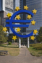 Germany, Hesse, Frankfurt, Euro-Skulptur, the 14 metre tall electronic sign by Ottmar Horl that shows a Euro currency sign with twelve stars around it, weighing 50 tonnes and located outside the Europ...